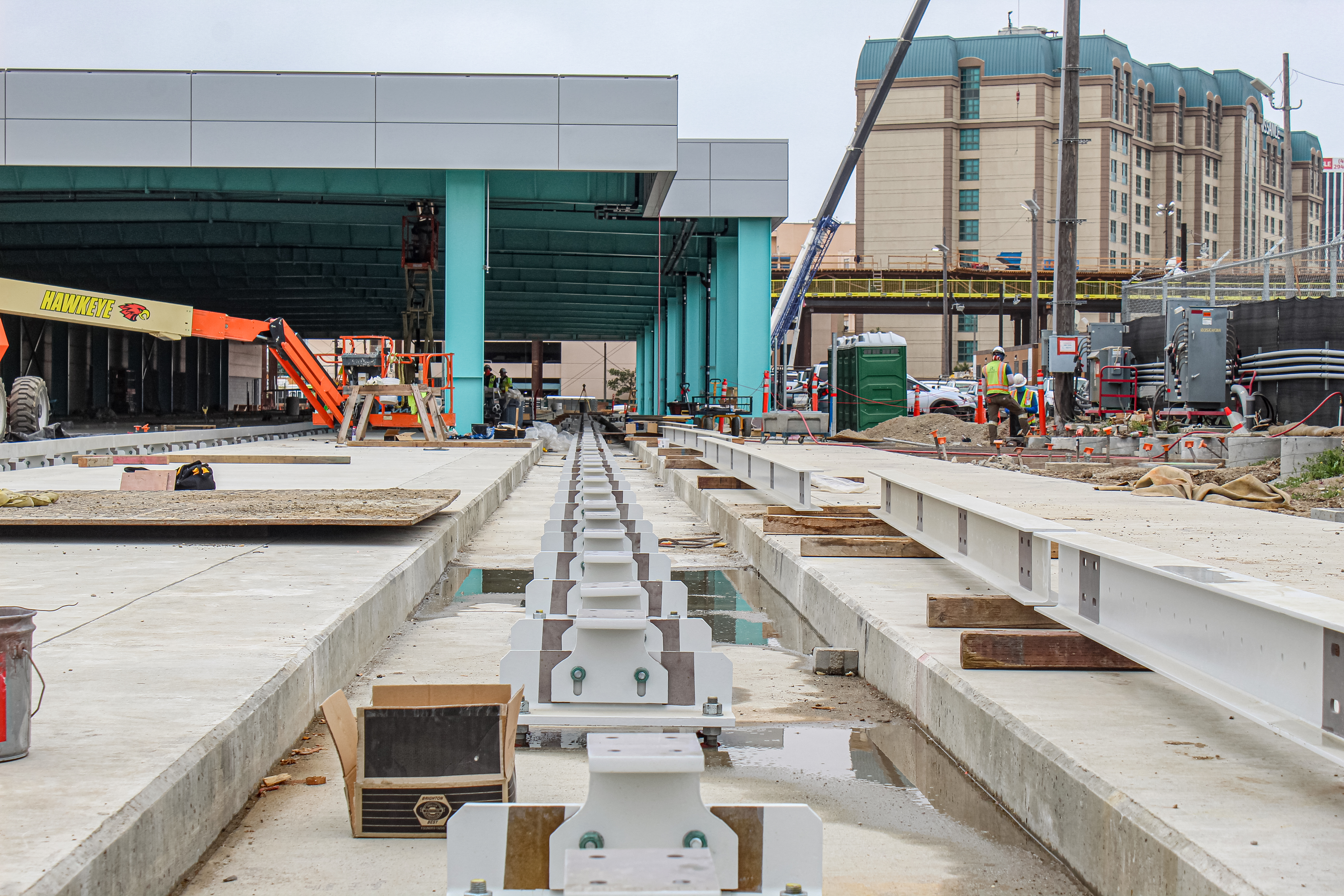 Track construction is most advanced at the future Maintenance and Storage Facility, where guidebeam and pivot switch installation is underway.