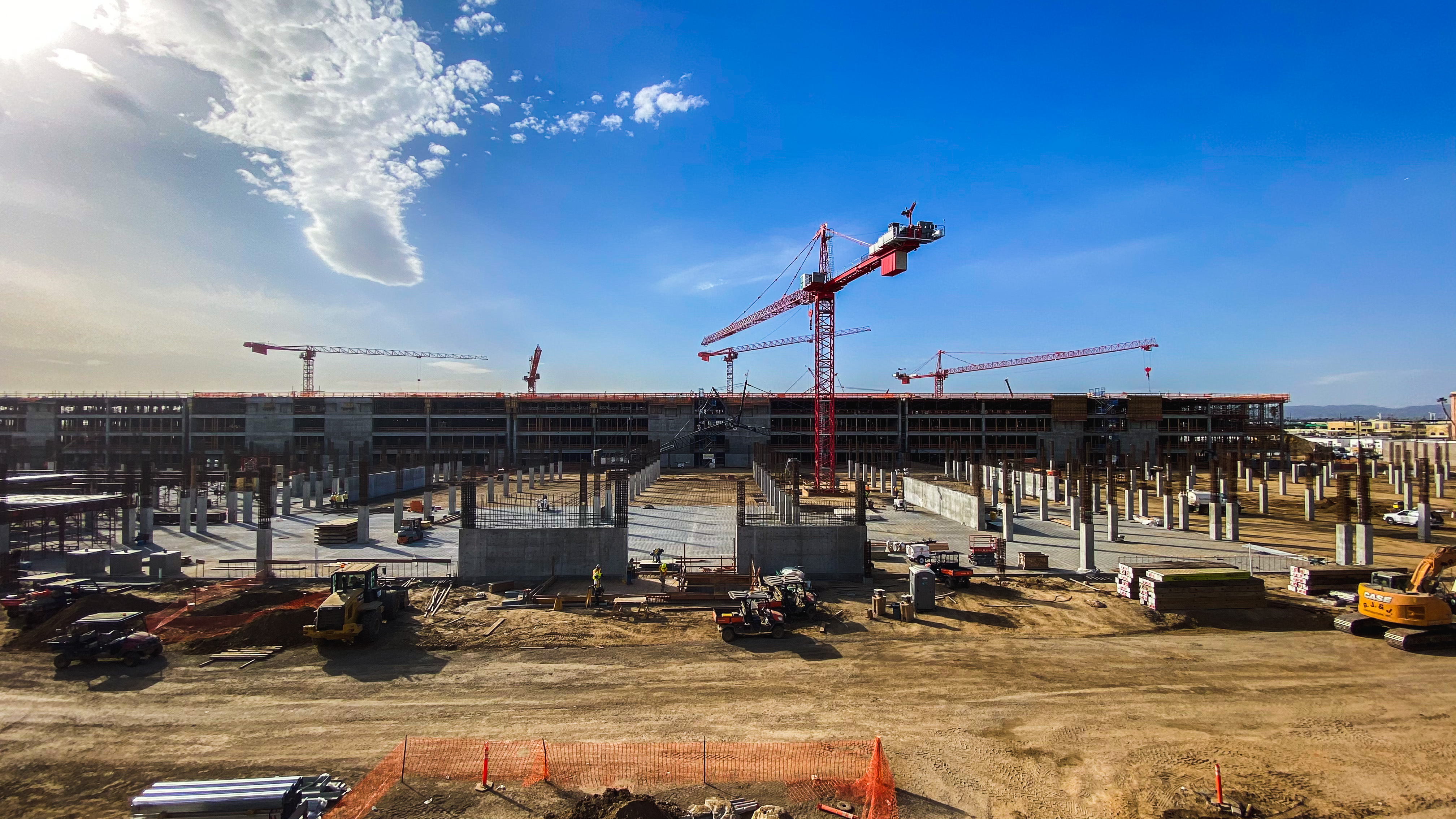 Five tower cranes at the Consolidated Rent-A-Car facility construction site.